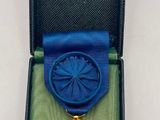 a blue box with a gold medal and a blue ribbon
