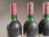 three bottles of wine sitting next to each other on a table