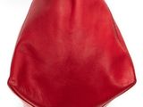 the large red bag is sitting on top of a white surface