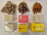 five different types of wigs on display on a table