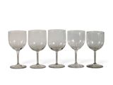 four wine glasses are lined up in a row on a white surface