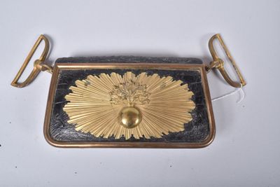 gold and black purse with a flower design on the front