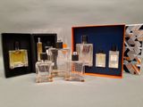 three bottles of perfume sitting next to each other on a table