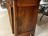 a wooden cabinet with a marble top in a store