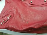 a red purse sitting on top of a white table