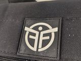 a close up of a black backpack with a white logo on it