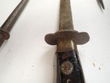 a close up of a pair of old knives on a table