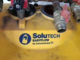 a yellow tank with a bunch of pipes attached to it