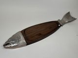 wooden and metal fish shaped serving board with a wooden handle