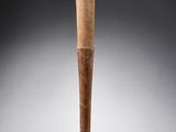 an old baseball bat with a wooden handle on a gray background