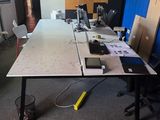 a long table with a laptop on it in the middle of a room