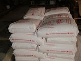 bags of cement sitting on a cart in a warehouse