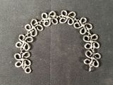 an image of a bracelet made out of metal rings on a black surface
