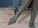 a bronze statue of a woman sitting on a bench