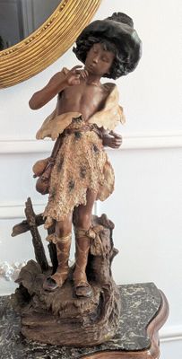 a statue of a woman holding a baby on a table