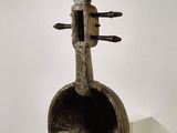 sculpture of a violin on a pedestal in a room