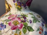 a white vase with a colorful floral design on it