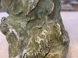 a statue of a dog that is sitting on a table