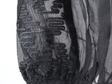 the back view of a black jacket with a black lace trim