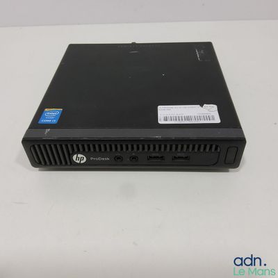 a close up of a small black computer on a white surface