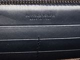 the inside of a black and tan purse with zippers