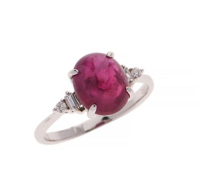 a close up of a ring with a ruby stone and diamonds