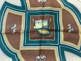 a brown and green scarf with a picture of a castle on it