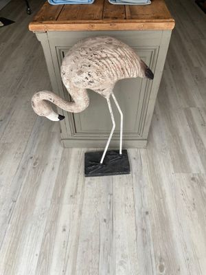 a statue of a flamingo standing on top of a kitchen island