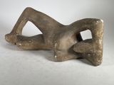 sculpture of a woman laying on her back on a white surface