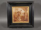 an old picture of a man and a woman in a wooded setting
