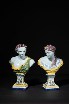 three porcelain busturines of women on pedestals against a black background