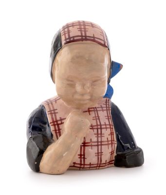 a small figurine of a woman sitting on the ground