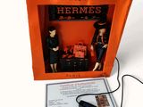 two figurines in a box with a remote in it