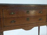 a small wooden table with a drawer on it