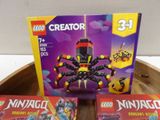 two legos are sitting on a table with a box of legos