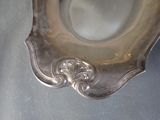 a silver plate with a decorative design on it