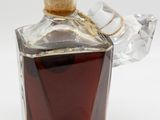 a glass bottle with a brown liquid inside of it