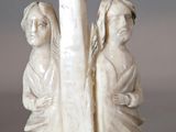 une image représentant une statue de deux femmes tenant une croix