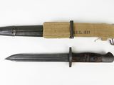an old knife and a small knife on a white surface