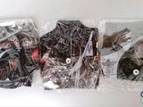 three bags of clothing wrapped in plastic on a table