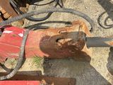 a picture of a red and black machine and some tools