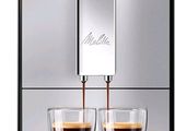 a close up of a coffee machine with two cups of coffee