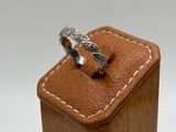 a close up of a ring sitting on top of a wooden box
