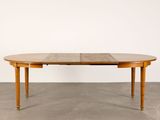 an oval dining table with two leaves on the top