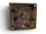 a picture of a metal object on a white surface