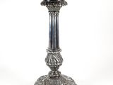 a silver candle that is sitting on a table