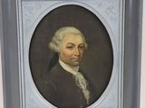 portrait of a man in a black coat and white hair