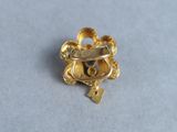 a close up of a gold ring on a white surface