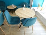 a table and chairs in a room with a blue wall
