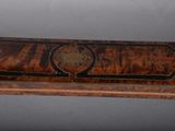 an image of a wooden bench with a decorative design on it